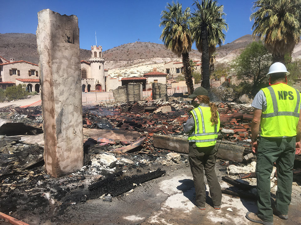 Rangers Stand in Remnants of Garage after Fire at Scottys Castle