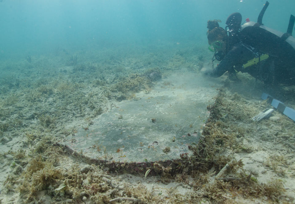 Diver examines underwater headstone of John Greer1