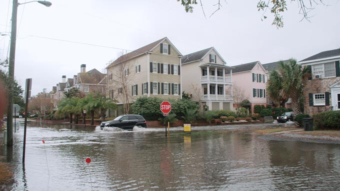 PHOTO flooded streets during a high tide event on a storm free day in Charleston SC